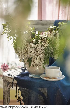 Acacia Flowers In White Vase. Still Life Wit Acacia Flowers On Vintage Shair.