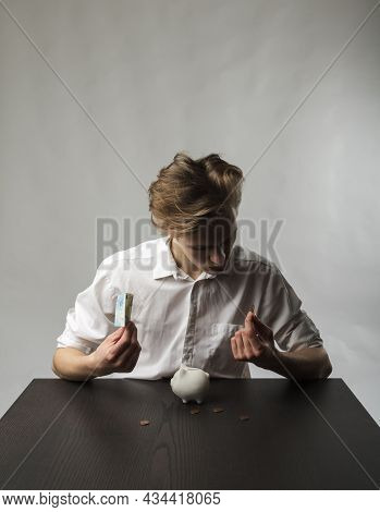 Young Man And Piggy Bank.