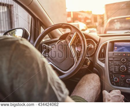 Man Driving In The Car With Sun Flare Throught Window