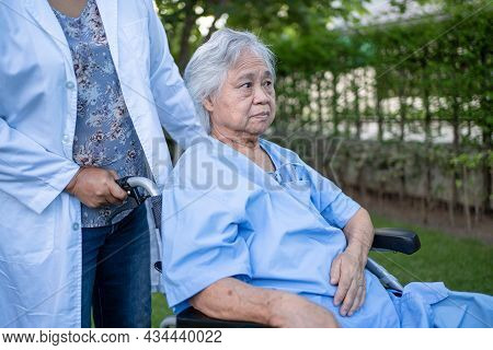 Doctor Help And Care Asian Senior Or Elderly Old Lady Woman Patient Sitting On Wheelchair At Park In