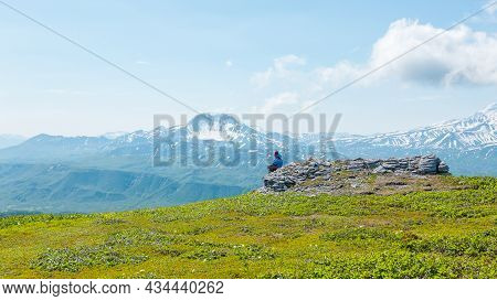 Kamchatka, Russia - July 10, 2018: Hiker Looking At The Ilyinsky Volcano, Kronotsky Reserve, Kamchat