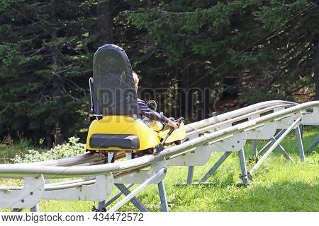 Little Boy Enjoying A Summer Fun Roller Alpine Coaster Ride In Rogla, Slovenia