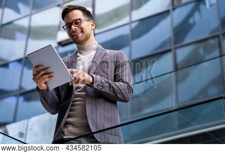 Successful Happy Business Man Working On Digital Tablet In Urban Background