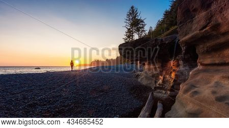 Adventurous Caucasian Woman At Sandcut Beach On The West Coast Of Pacific Ocean. Summer Sunny Sunset