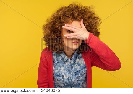 Portrait Of Curious Nosy Woman With Curly Hair Spying Rumors, Looking Through Fingers With Inquisiti