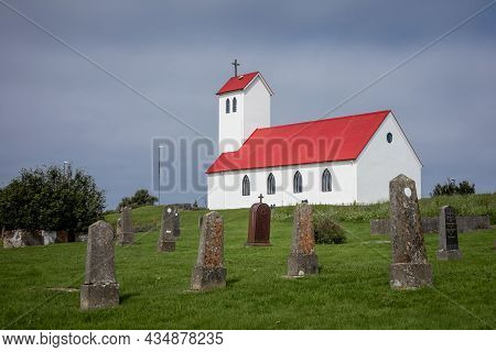 Hafnarfjordur, Iceland - July 17, 2021:
Traditional Icelandic Church With Red Rooftop, Old Vertical 