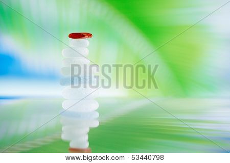 sea glass seaglass pile pyramid with reflection and seascape, shallow dof