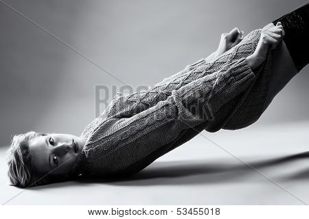 Young Woman On Floor Pulling Her Pullover