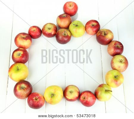 Juicy apples on white wooden table