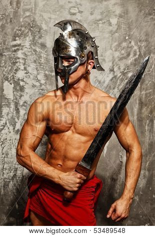 Gladiator with muscular body with sword and helmet