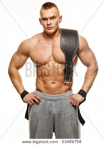 Muscular young sportsman with weight lifting belt 