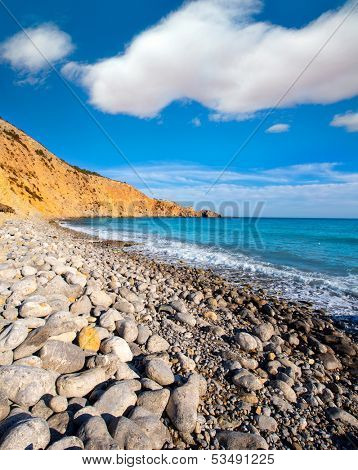 Ibiza Cala Jondal Beach with rolling stones in san Jose at Balearic Islands