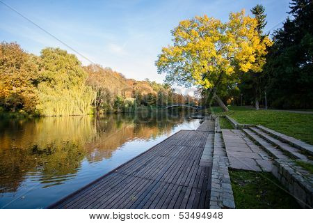 utumn Landscape. Park in Autumn. The bright colors of autumn in the park by the lake.