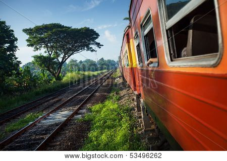 Train moving through coutryside in a sunny day. Sri Lanka
