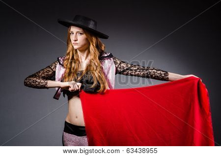 Redhead woman toreador against grey background