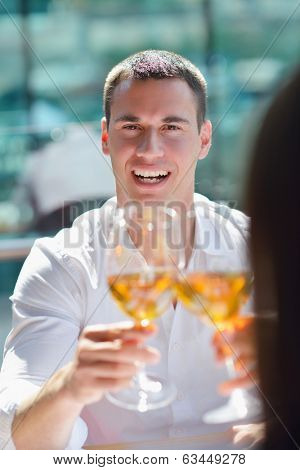 happy young couple having lanch at beautiful restaurant on by the sea on  beach