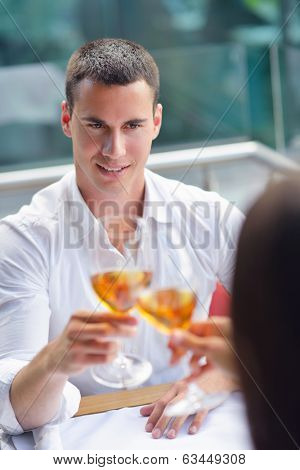 happy young couple having lanch at beautiful restaurant on by the sea on  beach
