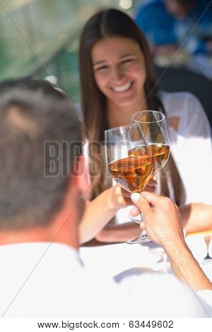 happy young couple having lanch at beautiful restaurant on by the sea on  beach