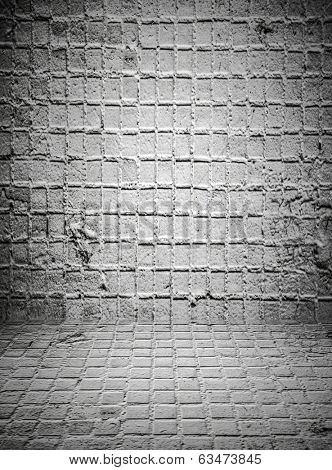 Abstract stonework background texture with old weathered dark stucco black paint stone cement wall in rural room Grungy cold rock surface in hard grime empty place with niello granite dull light floor