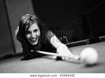Young brunette girl playing snooker