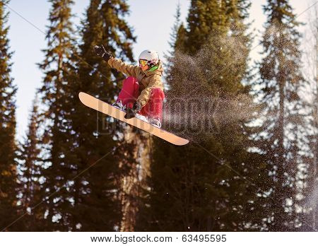 Snowboarder jumping through air with deep blue sky in background