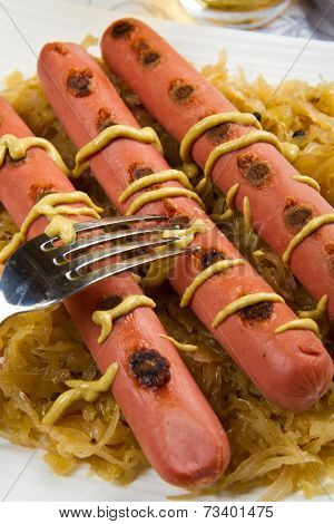 dish with roasted wurstel and sauerkraft