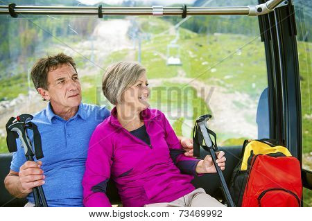 Senior hikers in cableway