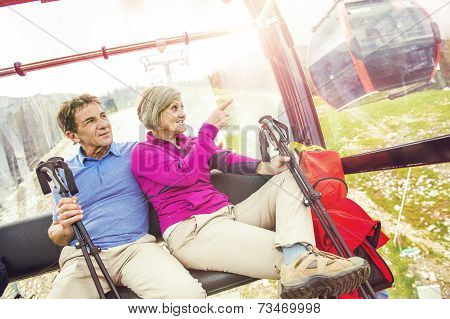 Senior hikers in cableway