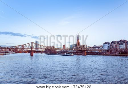FRANKFURT, HESSE - February 12 : River view of The Eiserner Steg.The Eiserner Steg is a pedestrian bridge in Frankfurt am Main built in 1868. City skyline on February 12, 2014 in Frankfurt, Germany.