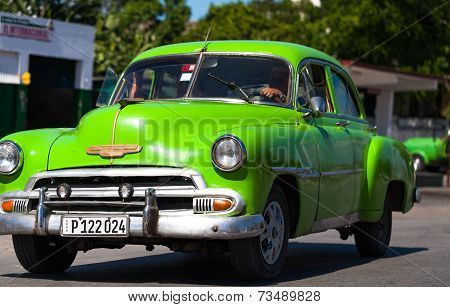 HAVANA,CUBA - June 27, 2014: Green classic car on the road in cuba