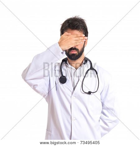 Doctor Covering His Eyes Over Isolated White Background