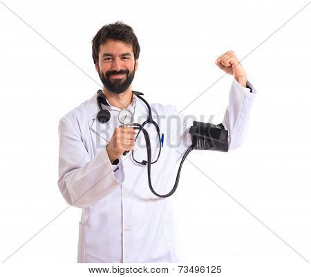 Strong Doctor With Blood Pressure Monitor Over White Background