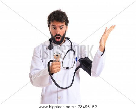 Surprised Doctor With Blood Pressure Monitor Over White Background