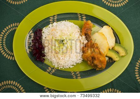 chicken served with white rice potato on a plate
