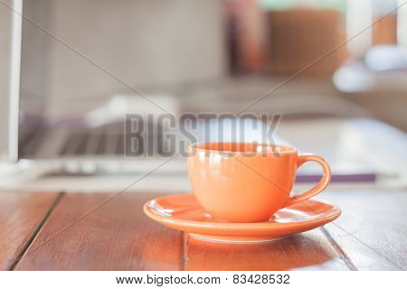 Mini Orange Coffee Cup On Work Station