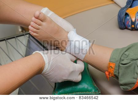 Child Boy With Bandage On Leg And Lying Down Hospital Bed