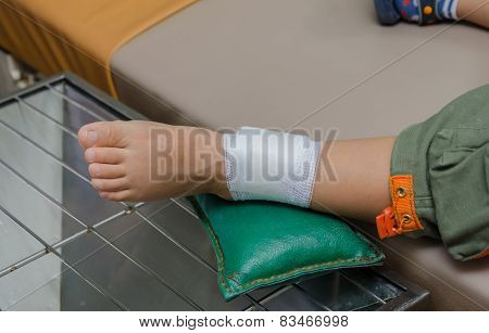 Child Boy With Bandage On Leg And Lying Down Hospital Bed