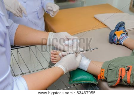 Child Boy With Bandage On Leg And Lying Down Hospital Bed