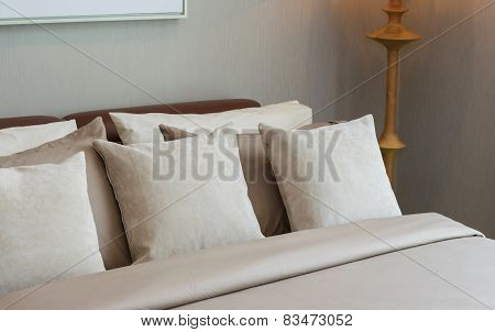 Classic Bedroom With Wooden Lamp And Pillows