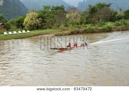 Vang Vieng, Lao P.d.r. - October 24 : Unidentified Tourists Are Rowing Kayak Boats In Song River On
