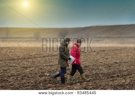 Farmers On Plowed Field