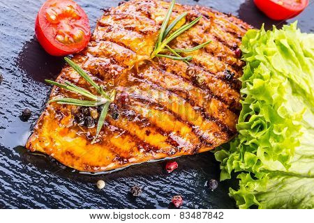 Steak chicken breast olive oil cherry tomatoes pepper and rosemary herbs.