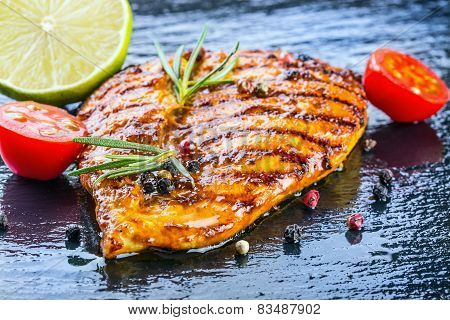 Steak chicken breast olive oil cherry tomatoes pepper and rosemary herbs.