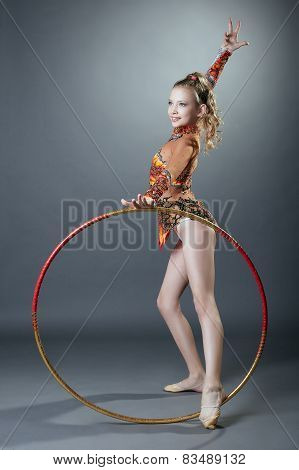 Free callisthenics. Cute young gymnast with hoop