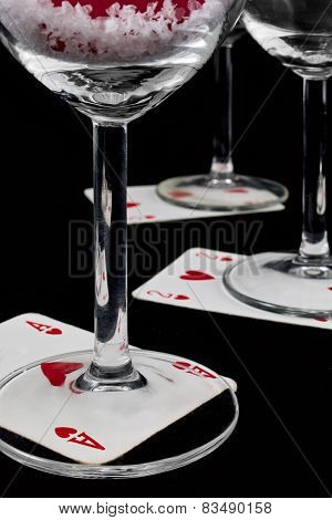 Playing Cards At The Bottom Of The Glasses