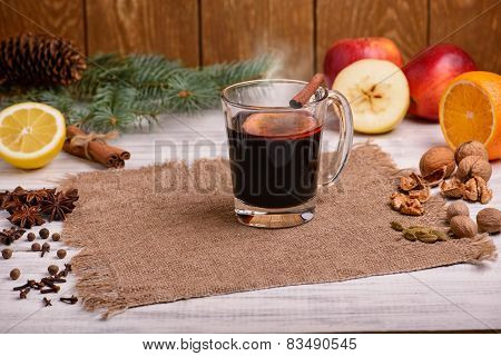 Mulled wine, punch and spices for glintwine on wooden background