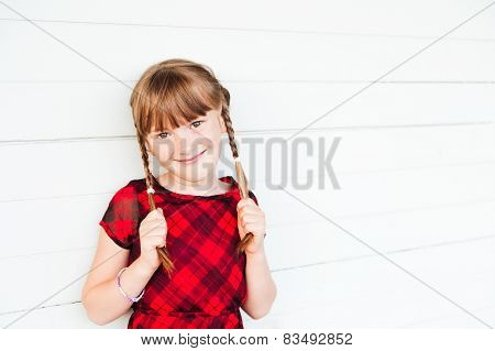 Outdoor portrait of a cute little girl against white background