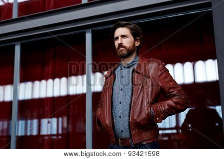 Portrait of fashionable mature hipster man dressed in pattern shirt standing indoors