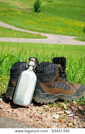 Hiking Boots In Front Of A Summer Meadow
