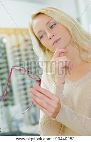 Lady comtemplating glasses